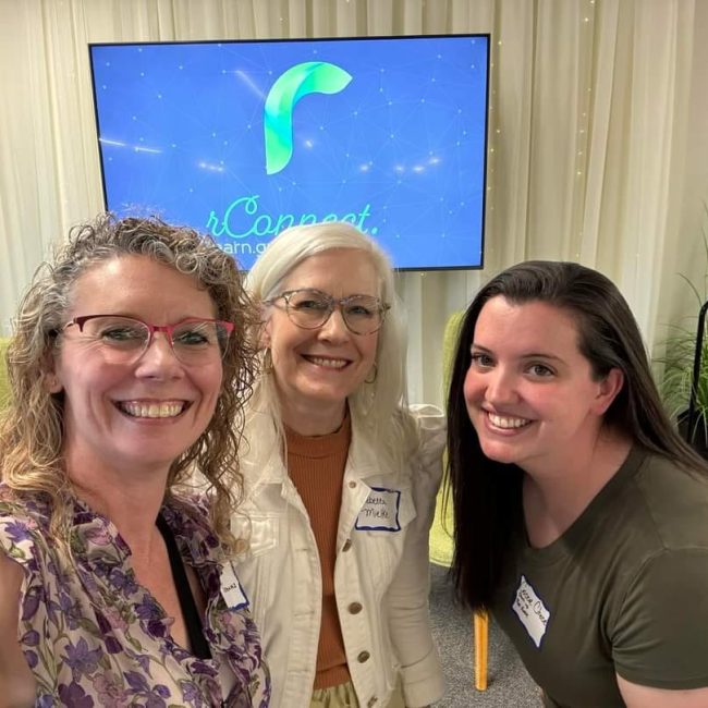 three women smiling at camera
