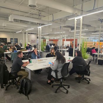 wide shot of all members at mastermind connect event in table groups