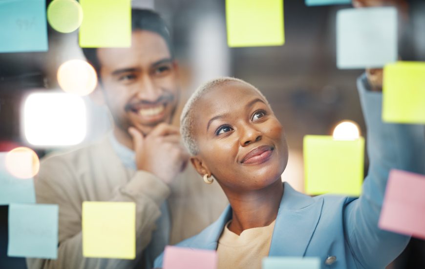 Writing, planning and business people with schedule, teamwork or agenda, sticky note or innovation